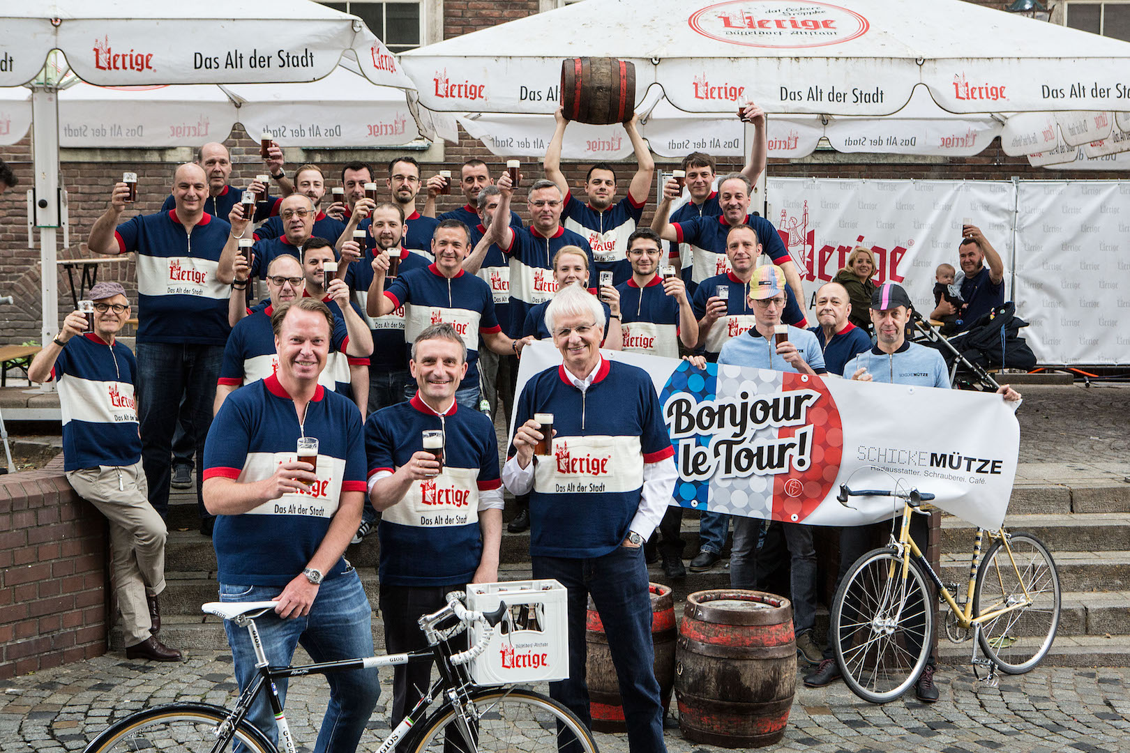 Düsseldorf, 01.07.2016 Uerige startet den Tour-Countdown Düsseldorf. Die Köbesse des Uerige freuen sich auf die Tour de France in Düsseldorf: Genau ein Jahr vor dem Grand Depart in der Landeshauptstadt wurden sie heute mit Retro-Trikots ausgestattet. Statt in die Pedale zu treten, bringen sie jedoch Höchstleistungen beim Biertransport und Fassrollen. Will sagen: Die Höchstleistung der Radfahrer entspricht dem Tagespensum eines Uerige-Köbes - höchstens unterstützt mit dem leckeren Dröppke als legalem Doping. Freitag arbeiten einige der Köbesse in den Trikots, beim Grand Depart in einem Jahr werden es alle sein. Vielleicht gibt es dann eine limitierte frei verkäufliche Anzahl an Trikots. Oberbürgermeister Thomas Geisel freut sich über die Unterstützung aus der Nachbarschaft und schaute gestern bei der Trikot-Anprobe vorbei, ebenso Küchenchef Bernard (Koch im Fischhaus an der Berger Straße) als echter französischer Nachbar. Foto Bernd Schaller Kiefernstr. 18 40233 Düsseldorf info@schallerfoto.de 00491776769111